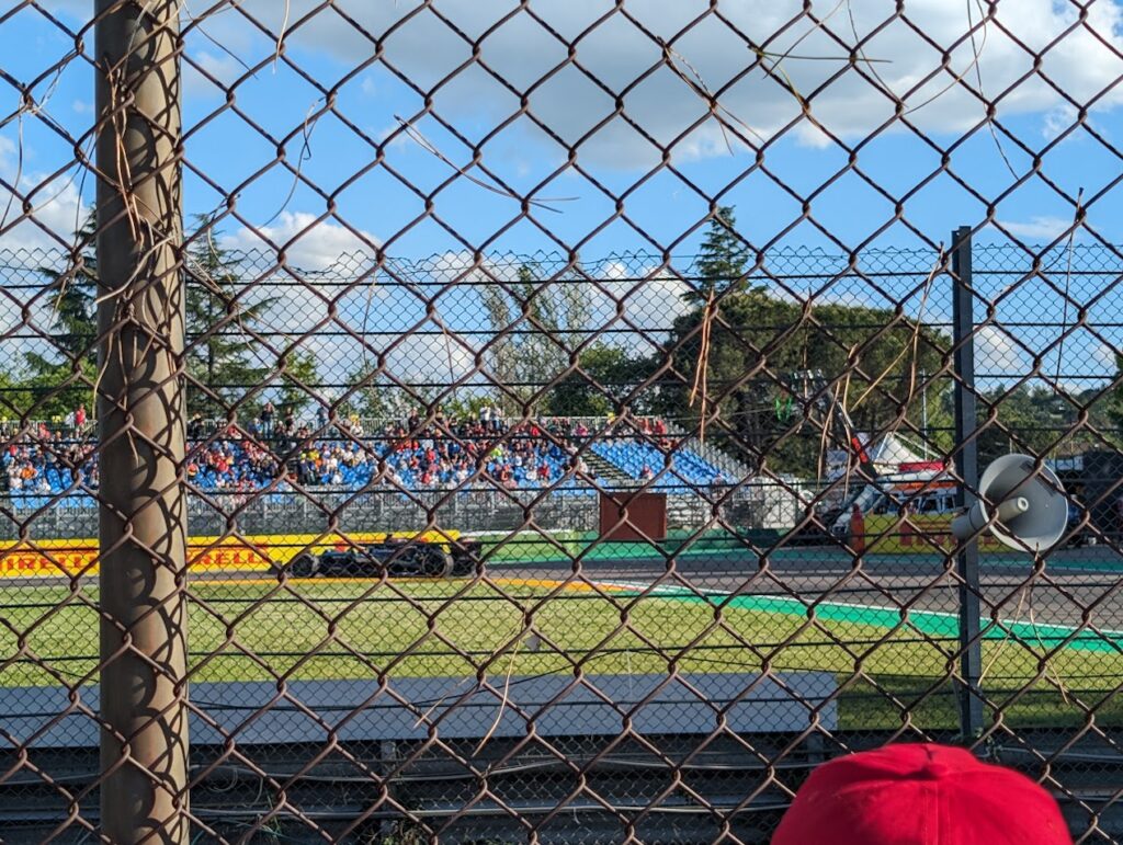 GA view towards Gresini grandstands with a Mercedes driver passing through.