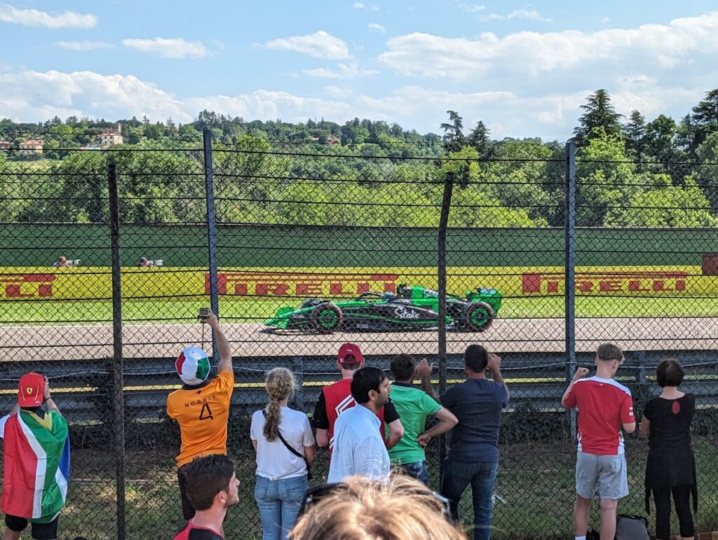 The GA area between Acque Minerali provides up close action as a Kick Sauber team driver speeds by.