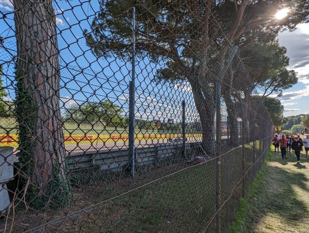 The trees lining the straight out of Acque Minerali restricts the view from the Acque Minerali 3 grandstands but they provide good shade for the GA spectators.