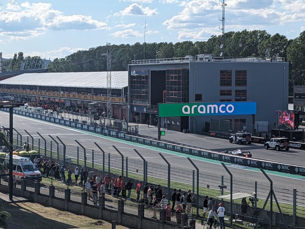 The western edge of the Rivazza 1 grandstands provides a view of the pit entrance and pit lane action.