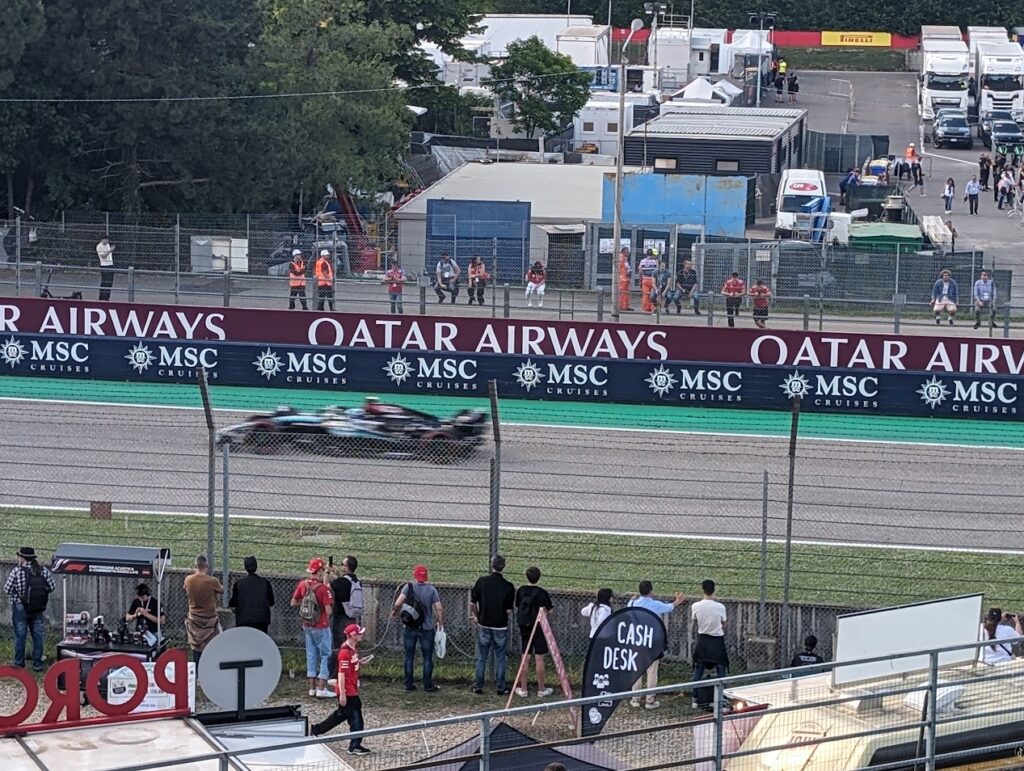 George Russel zooms in front of the Rivazza 1 grandstands and down the straight.