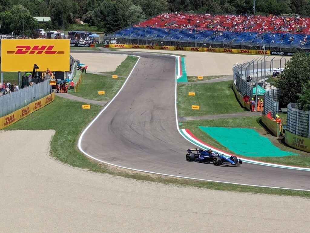 A Williams team car enters Tosa corner as viewed from the Tosa grandstands.