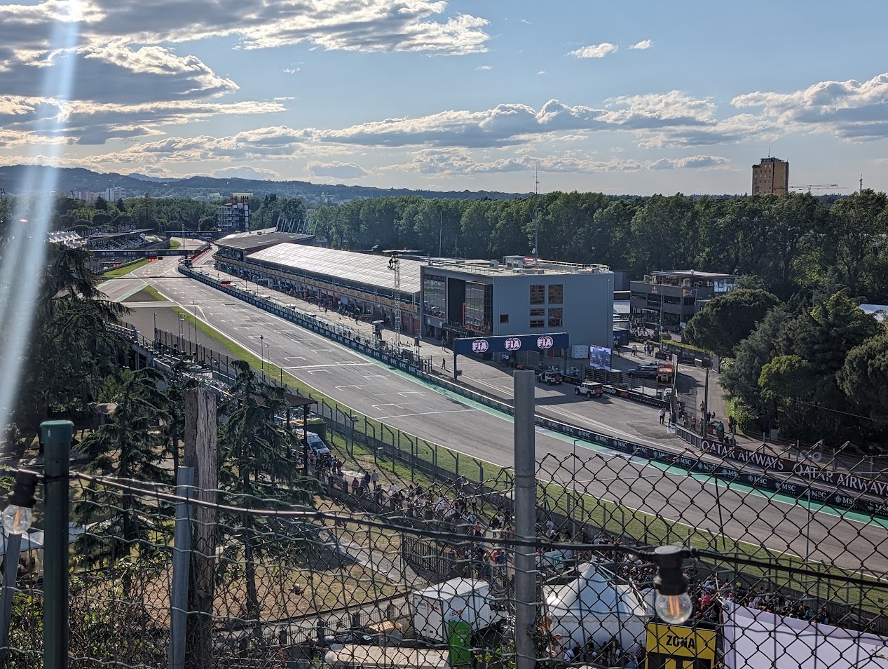 Elevated view of the pit lane and start/finish line from the Rivazza Hotel viewing area above the Rivazza 1 grandstands.