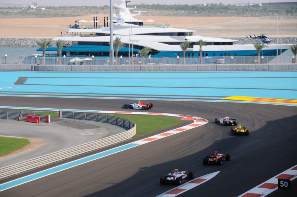 GP2 drivers chasing the lead car on the apex at Yas Marina in Abu Dhabi.