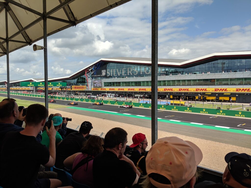 Silverstone main grandstands during practice session.  View across the start/finish line into the pits.