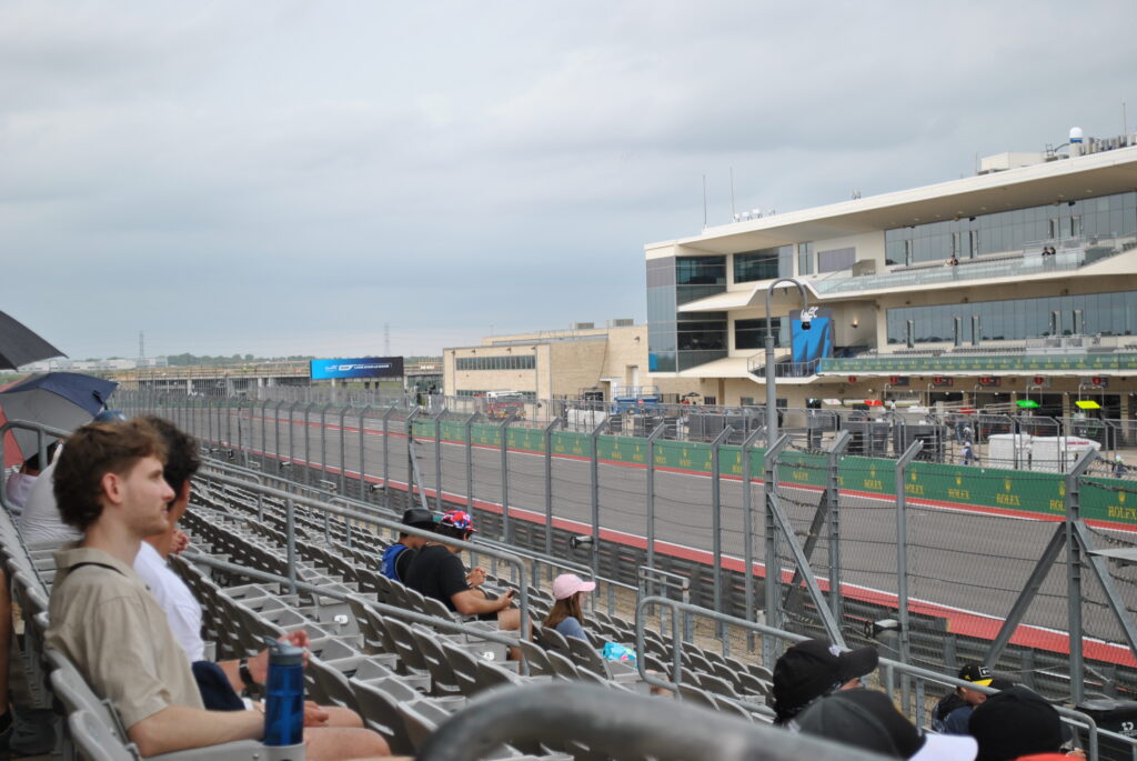 Lower grandstand view from the left side near the towards T20 and the pit lane entrance.
