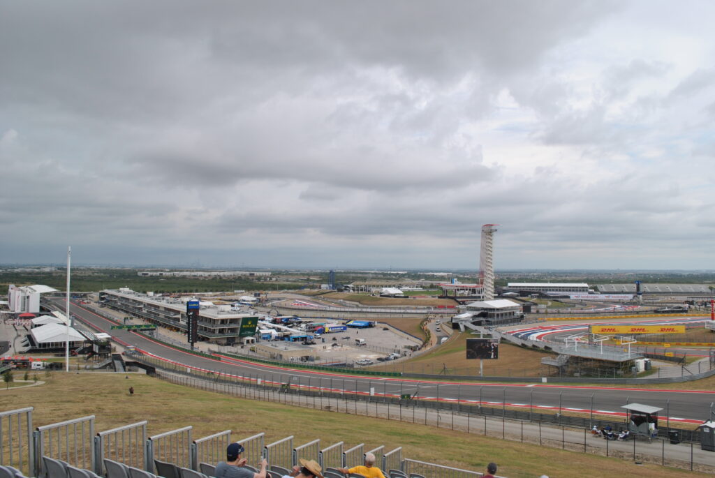 View of the start-finish straight towards the T1 entry from the left side of the T1 Grandstand.