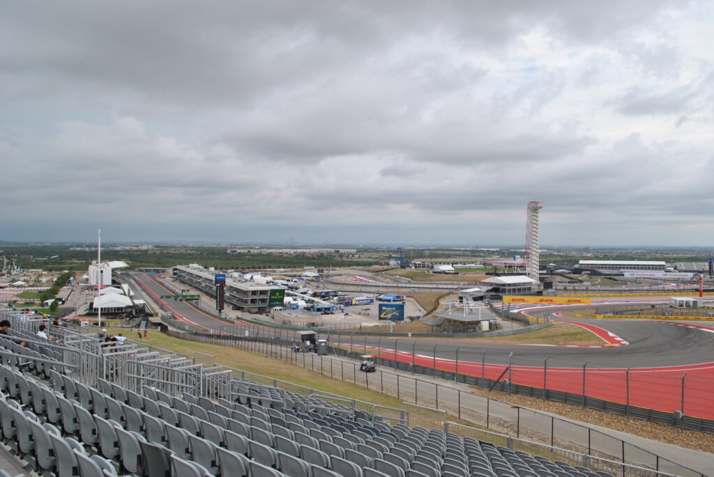 View of the start-finish straight, T1, and T2 from the right side of the T1 Grandstand.