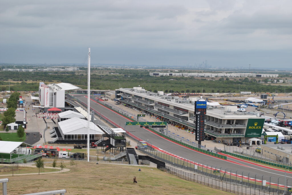 View of the main straight and pits from the left-most side of the T1 Grandstands.  